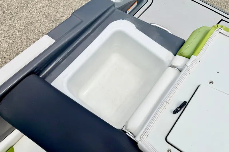 Slide: The Image of 2018 Glastron GT 185 boat interior with storage compartment and cushioned seating. - 48