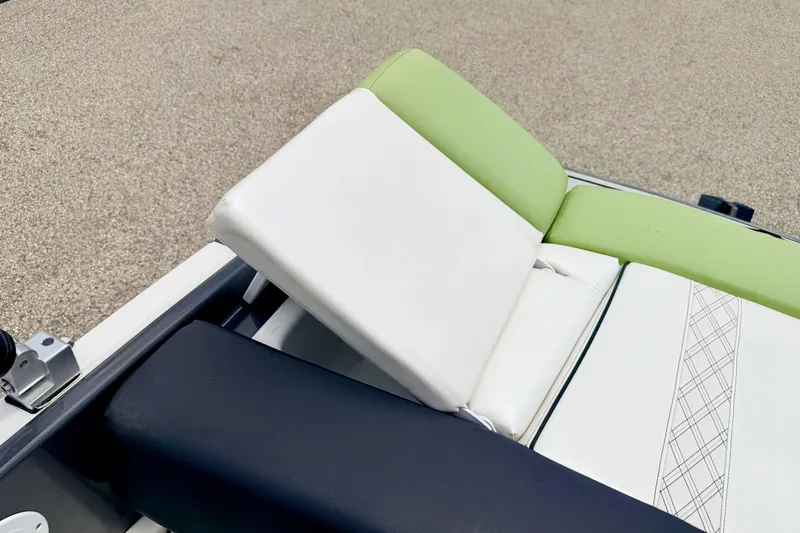 Slide: The Image of 2018 Glastron GT 185 boat seat with white and green upholstery, featuring a sleek design. - 49