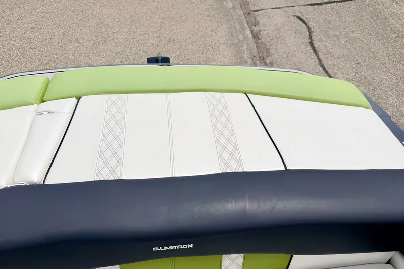 Slide: The Image of 2018 Glastron GT 185 boat seat with green and white upholstery design. - 50