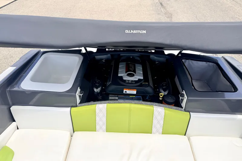 Slide: The Image of 2018 Glastron GT 185 boat engine compartment with seating and storage areas. - 51
