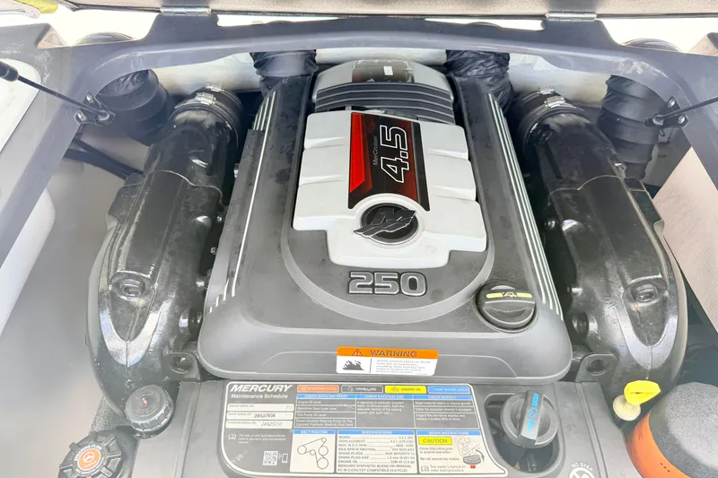 Slide: The Image of 2018 Glastron GT 185 engine compartment featuring a powerful 4.5L Mercury engine. - 52