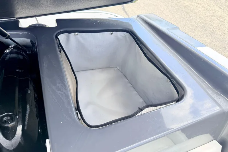 Slide: The Image of Storage compartment of a 2018 Glastron GT 185 boat, featuring a clean interior. - 53