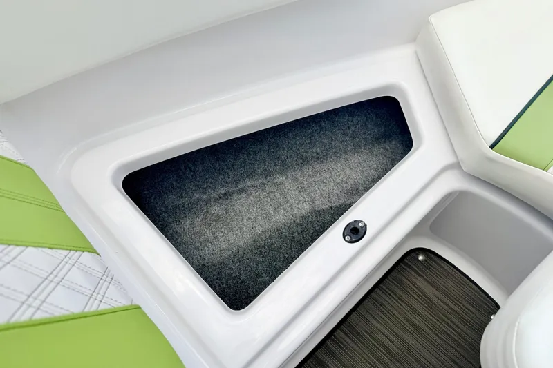 Slide: The Image of 2018 Glastron GT 185 boat interior storage compartment with green and white seating. - 55