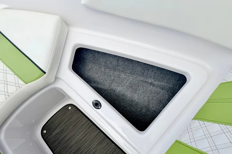 Slide: The Image of 2018 Glastron GT 185 boat interior storage compartment with green and white seating. - 57