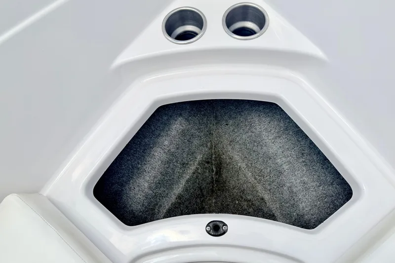 Slide: The Image of Interior storage compartment of 2018 Glastron GT 185 boat with cup holders. - 59