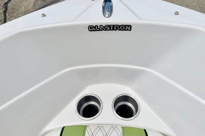 Slide: The Image of 2018 Glastron GT 185 boat interior with cup holders and logo. - 60