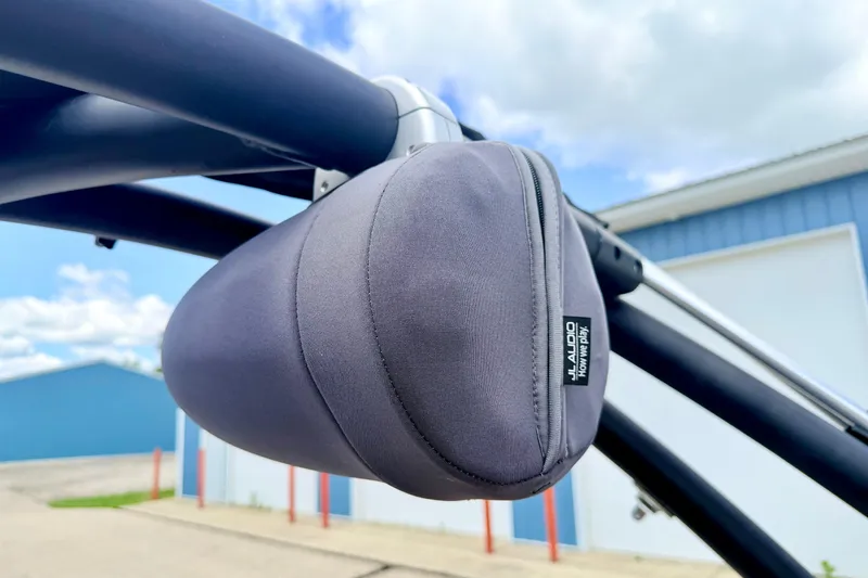 Slide: The Image of Protective cover on a 2018 Glastron GT 185 boat's audio speaker, with blue sky background. - 64