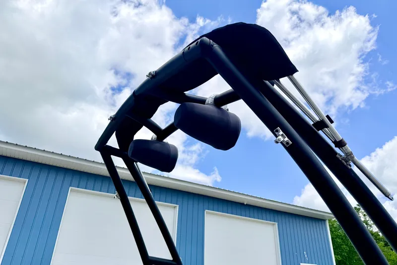 Slide: The Image of 2018 Glastron GT 185 boat tower against blue sky and building background. - 68