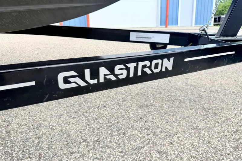 Slide: The Image of Trailer of 2018 Glastron GT 185 boat on pavement background. - 70