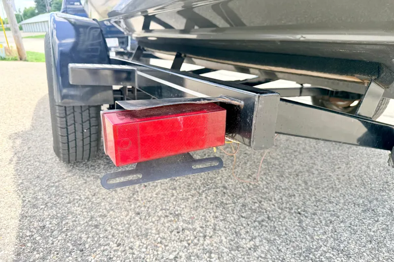 Slide: The Image of Trailer light on a 2018 Glastron GT 185 boat trailer, parked on asphalt. - 74
