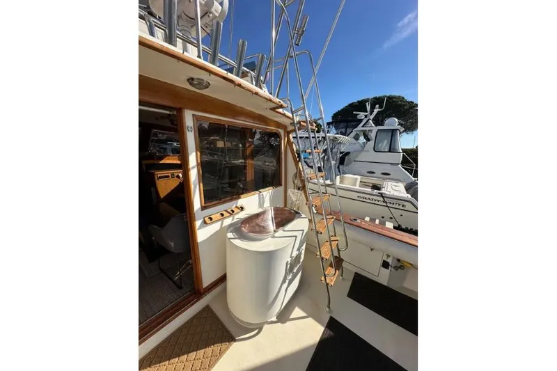 Slide: The Image of 1985 Egg Harbor 33 Sedan boat deck with ladder and interior view. - 10