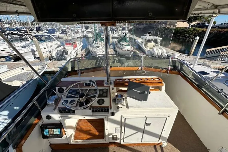 Slide: The Image of Cockpit view of 1985 Egg Harbor 33 Sedan yacht docked at marina. - 12