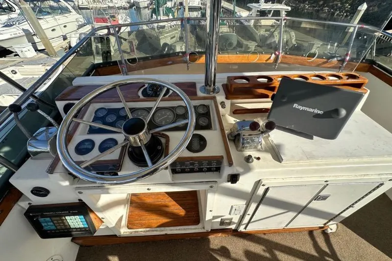 Slide: The Image of Cockpit of 1985 Egg Harbor 33 Sedan with steering wheel and Raymarine navigation system. - 13