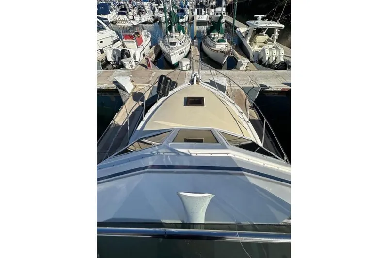 Slide: The Image of 1985 Egg Harbor 33 Sedan yacht docked at a marina, surrounded by other boats. - 15