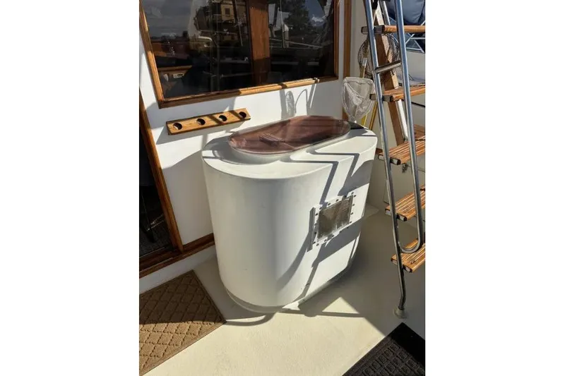 Slide: The Image of 1985 Egg Harbor 33 Sedan boat deck with ladder and fishing equipment. - 18