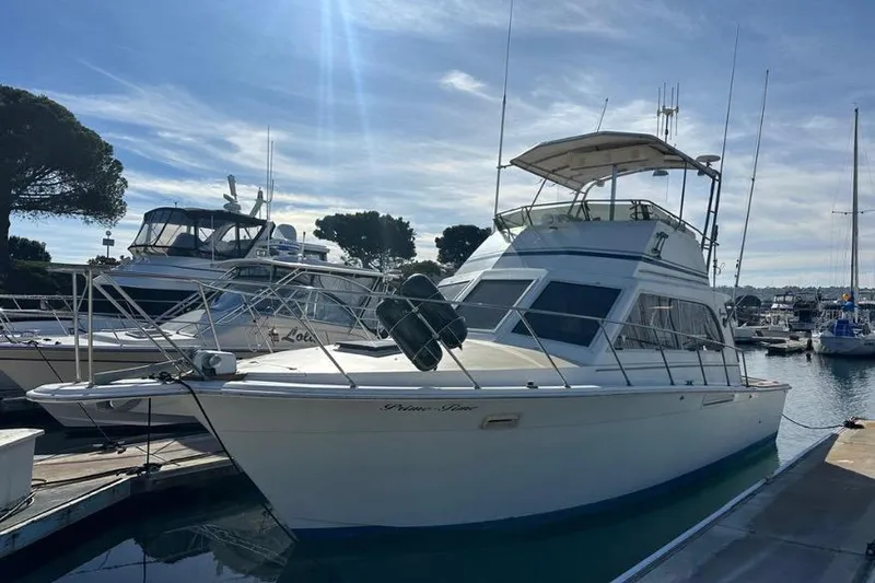 Slide: The Image of 1985 Egg Harbor 33 Sedan yacht docked at marina under clear blue sky. - 2
