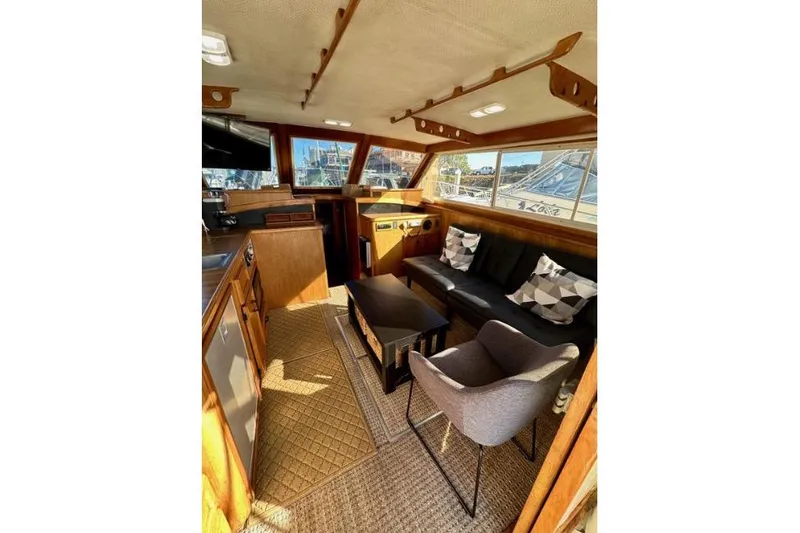 Slide: The Image of Interior of a 1985 Egg Harbor 33 Sedan yacht with cozy seating and wooden accents. - 20