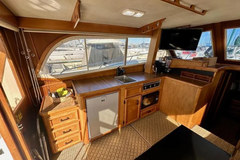 Slide: The Image of Interior of 1985 Egg Harbor 33 Sedan yacht with wooden cabinetry and kitchenette. - 23