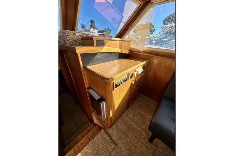 Slide: The Image of 1985 Egg Harbor 33 Sedan interior with wooden cabinetry and navigation equipment. - 26