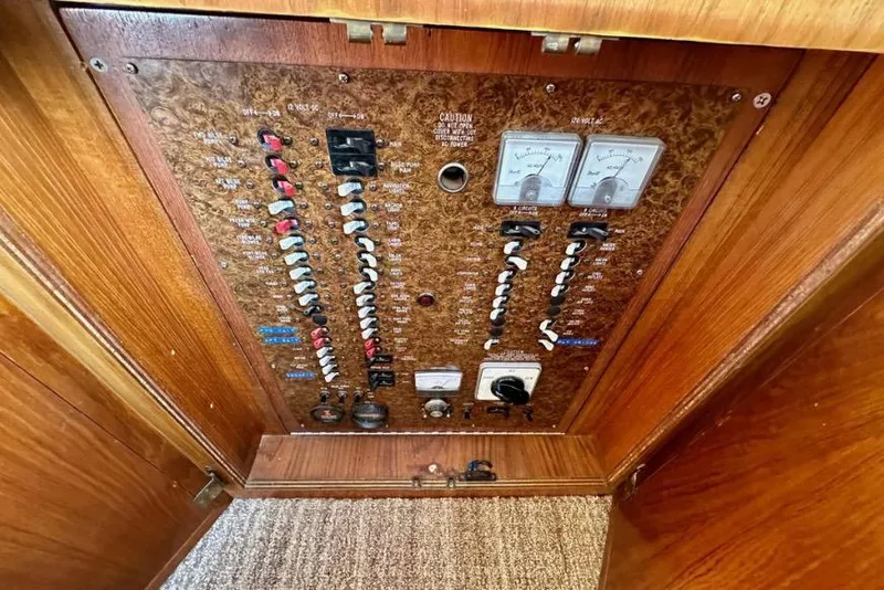 Slide: The Image of Electrical panel of a 1985 Egg Harbor 33 Sedan boat with switches and meters. - 27