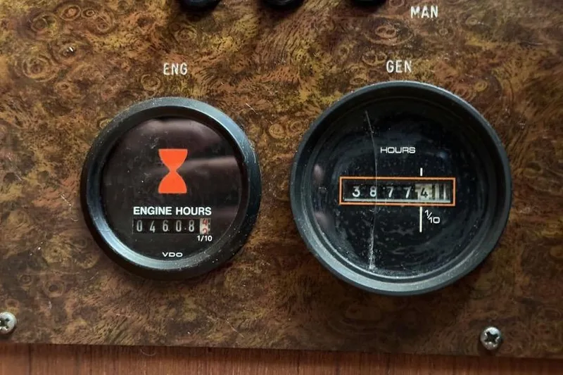 Slide: The Image of Close-up of Egg Harbor 33 Sedan 1985 engine and generator hour meters. - 28
