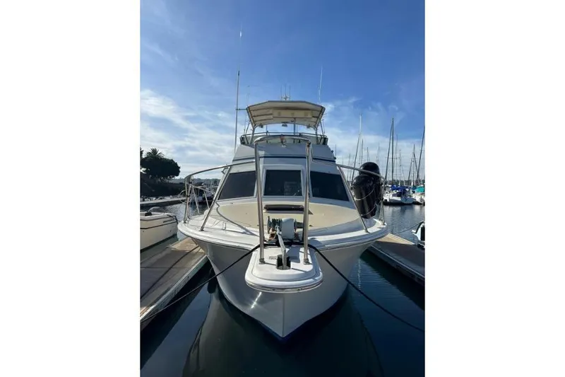 Slide: The Image of 1985 Egg Harbor 33 Sedan yacht docked at marina under clear blue sky. - 3
