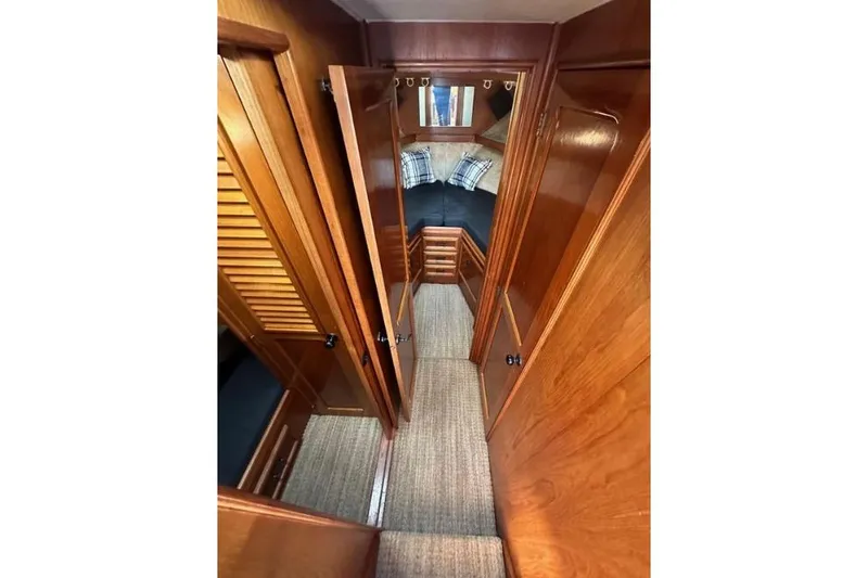 Slide: The Image of Interior view of 1985 Egg Harbor 33 Sedan, featuring wood paneling and cozy cabin space. - 32