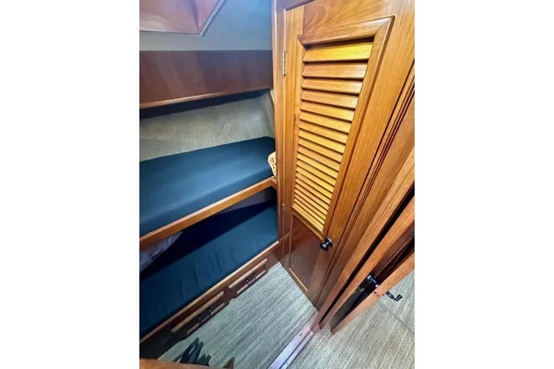 Slide: The Image of Interior of 1985 Egg Harbor 33 Sedan with wooden bunk beds and closet. - 34