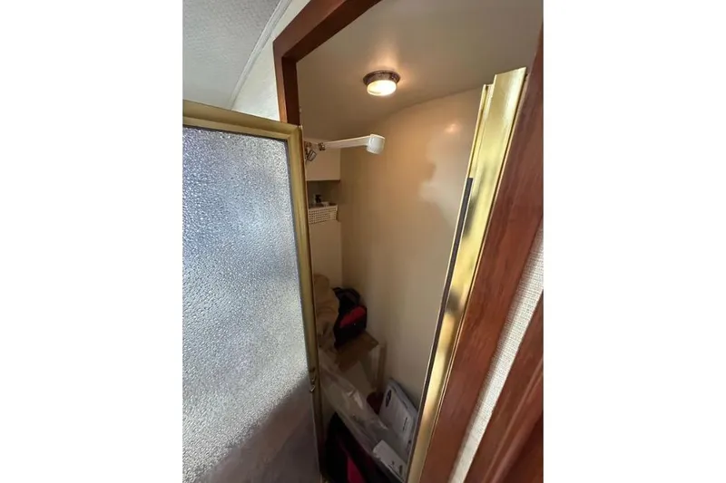 Slide: The Image of Interior of 1985 Egg Harbor 33 Sedan boat showing a compact shower area. - 36