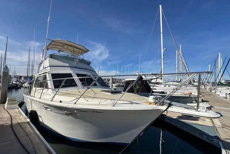 Slide: The Image of 1985 Egg Harbor 33 Sedan yacht docked at marina under clear blue sky. - 4