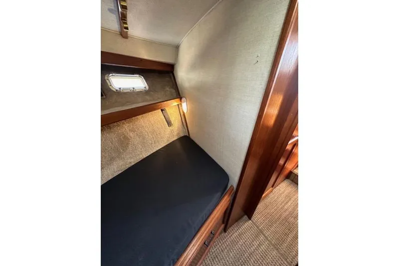 Slide: The Image of 1985 Egg Harbor 33 Sedan cabin interior with cozy bed and porthole window. - 40