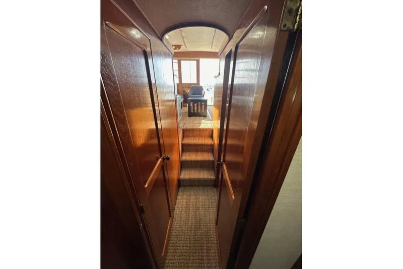 Slide: The Image of Interior view of 1985 Egg Harbor 33 Sedan yacht with wooden finishes and carpeted steps. - 41