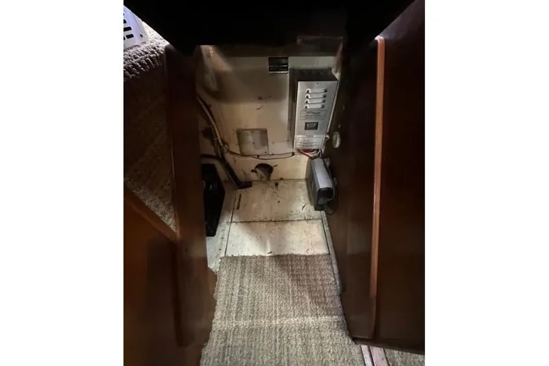 Slide: The Image of Interior view of 1985 Egg Harbor 33 Sedan, showing electrical panel and carpeted flooring. - 42