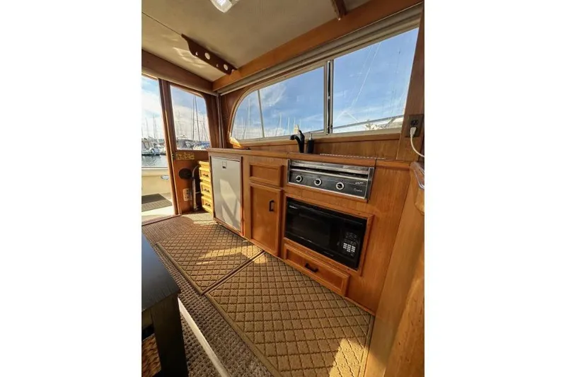Slide: The Image of 1985 Egg Harbor 33 Sedan interior with wooden cabinetry and kitchen appliances. - 46