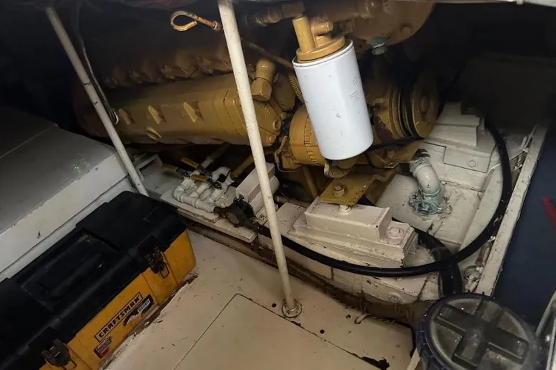 Slide: The Image of Engine room of 1985 Egg Harbor 33 Sedan with visible machinery and tools. - 51