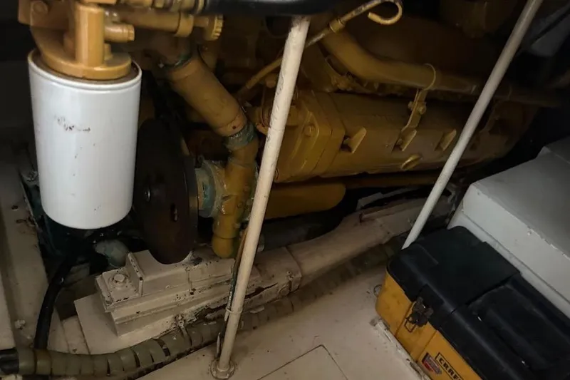 Slide: The Image of Engine compartment of a 1985 Egg Harbor 33 Sedan boat, showcasing mechanical components. - 52