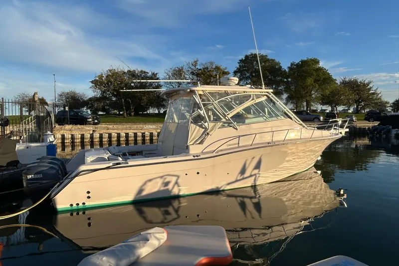 The Image of 2007 Grady-White Express 360 boat docked on calm water under a clear sky. - 0