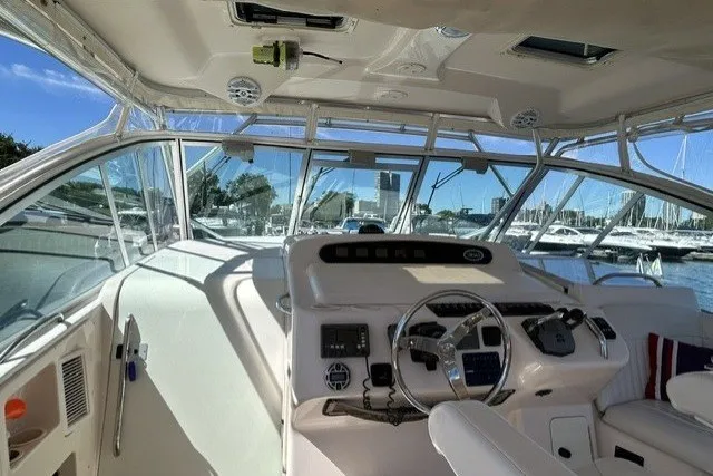 Slide: The Image of 2007 Grady-White Express 360 boat cockpit with steering wheel and navigation controls. - 71