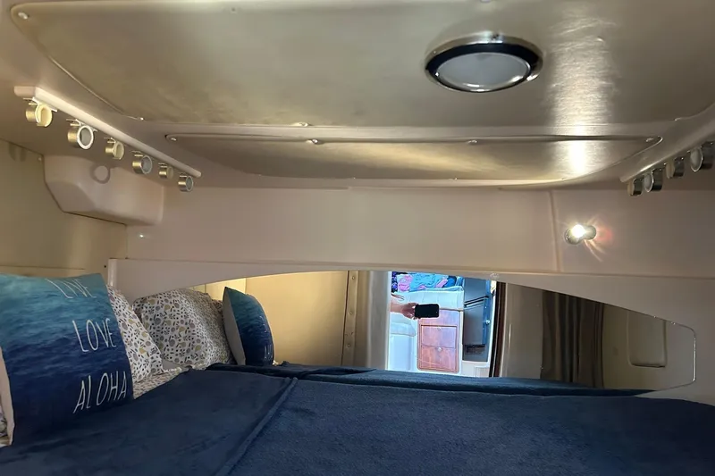 Slide: The Image of Interior cabin of 2007 Grady-White Express 360 with cozy bedding and ambient lighting. - 12