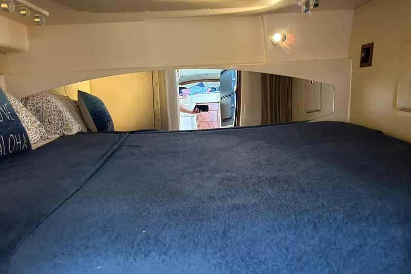 Slide: The Image of 2007 Grady-White Express 360 cabin interior with cozy bedding and ambient lighting. - 13