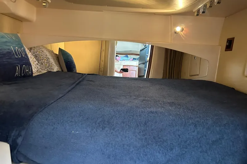 Slide: The Image of Interior cabin of 2007 Grady-White Express 360 with cozy bedding and ambient lighting. - 14