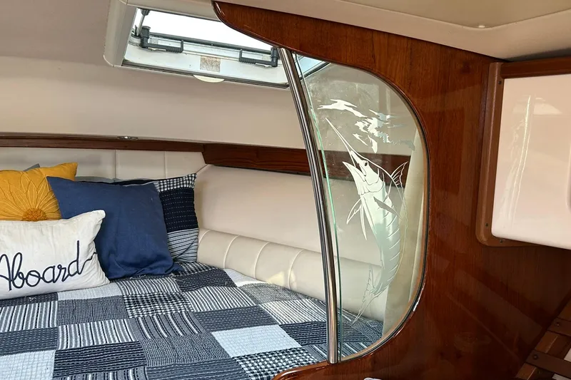 Slide: The Image of Cozy cabin interior of 2007 Grady-White Express 360 with nautical decor and etched glass. - 18