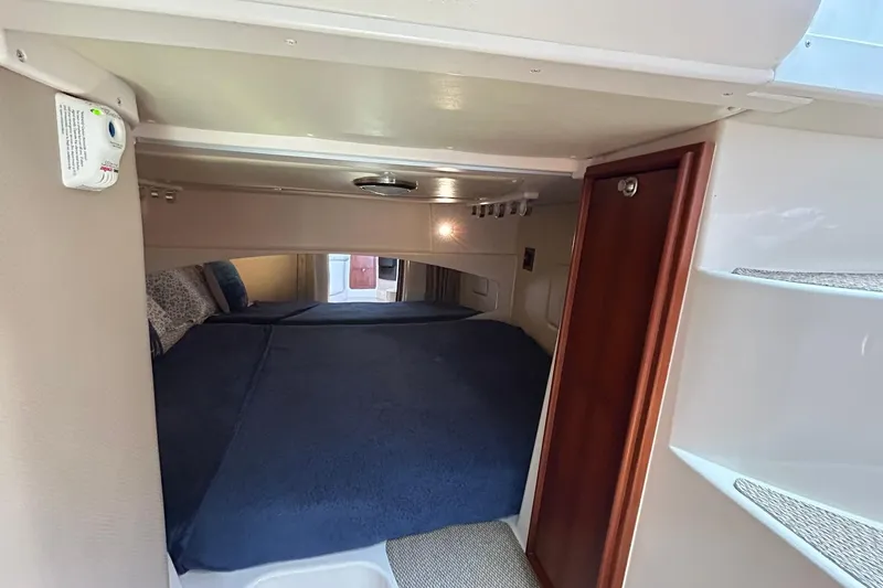 Slide: The Image of 2007 Grady-White Express 360 cabin interior with cozy bed and wooden accents. - 19