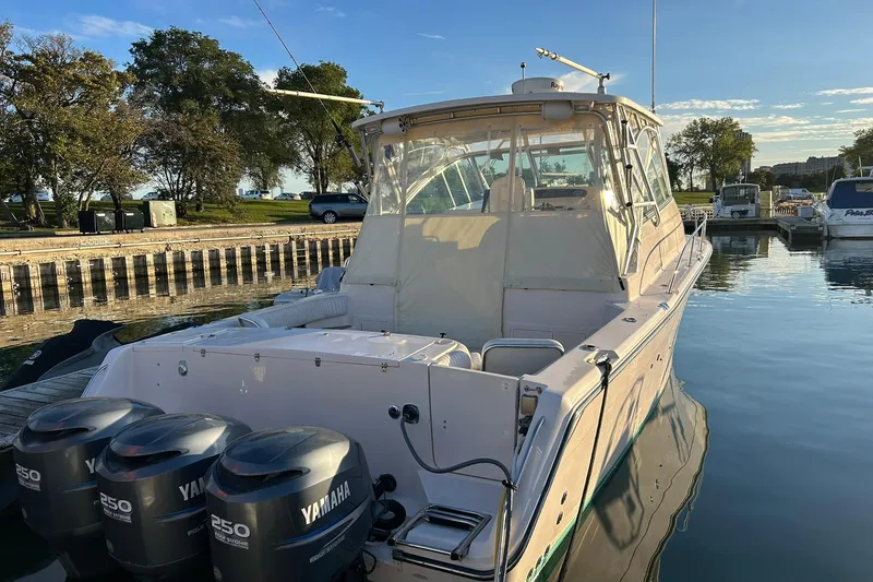 Slide: The Image of 2007 Grady-White Express 360 boat docked with Yamaha engines, calm water, and clear sky. - 2