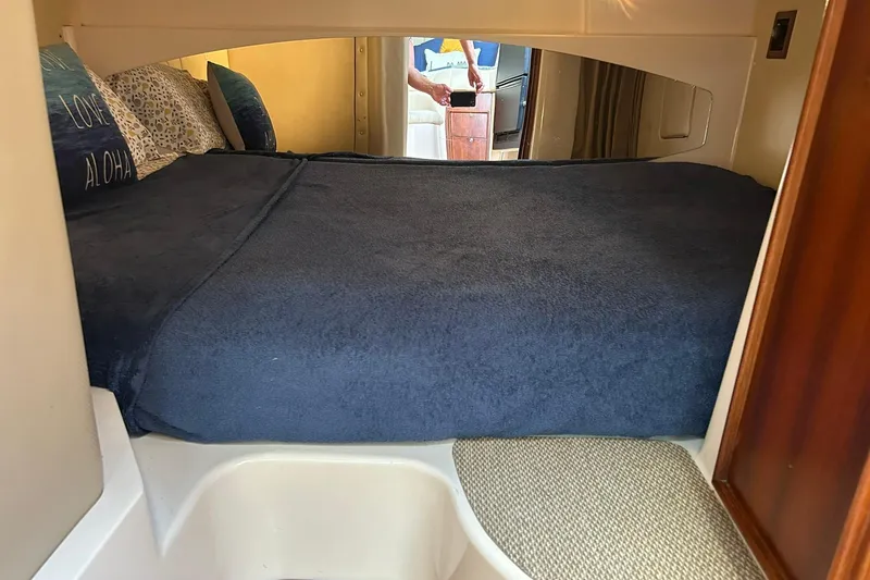 Slide: The Image of 2007 Grady-White Express 360 cabin interior with cozy bed and pillows. - 20