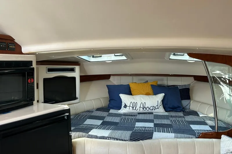 Slide: The Image of Cozy cabin interior of 2007 Grady-White Express 360 with bed and appliances. - 23