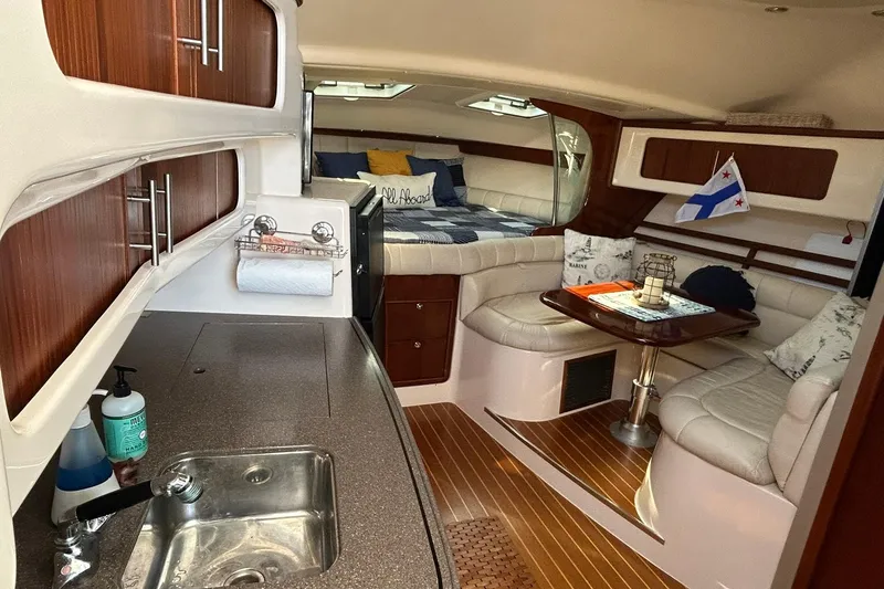 Slide: The Image of 2007 Grady-White Express 360 interior with kitchen, seating, and cozy sleeping area. - 27