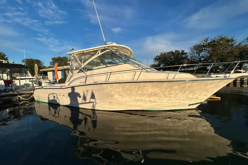 Slide: The Image of 2007 Grady-White Express 360 boat docked on calm water under a clear blue sky. - 28