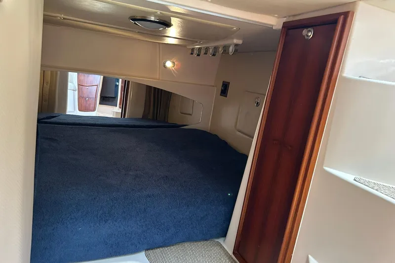 Slide: The Image of Interior cabin of 2007 Grady-White Express 360 with cozy bed and wooden accents. - 3