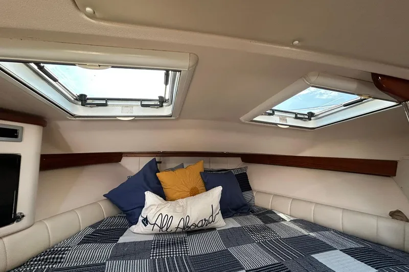 Slide: The Image of 2007 Grady-White Express 360 cabin interior with skylights and cozy bedding. - 31
